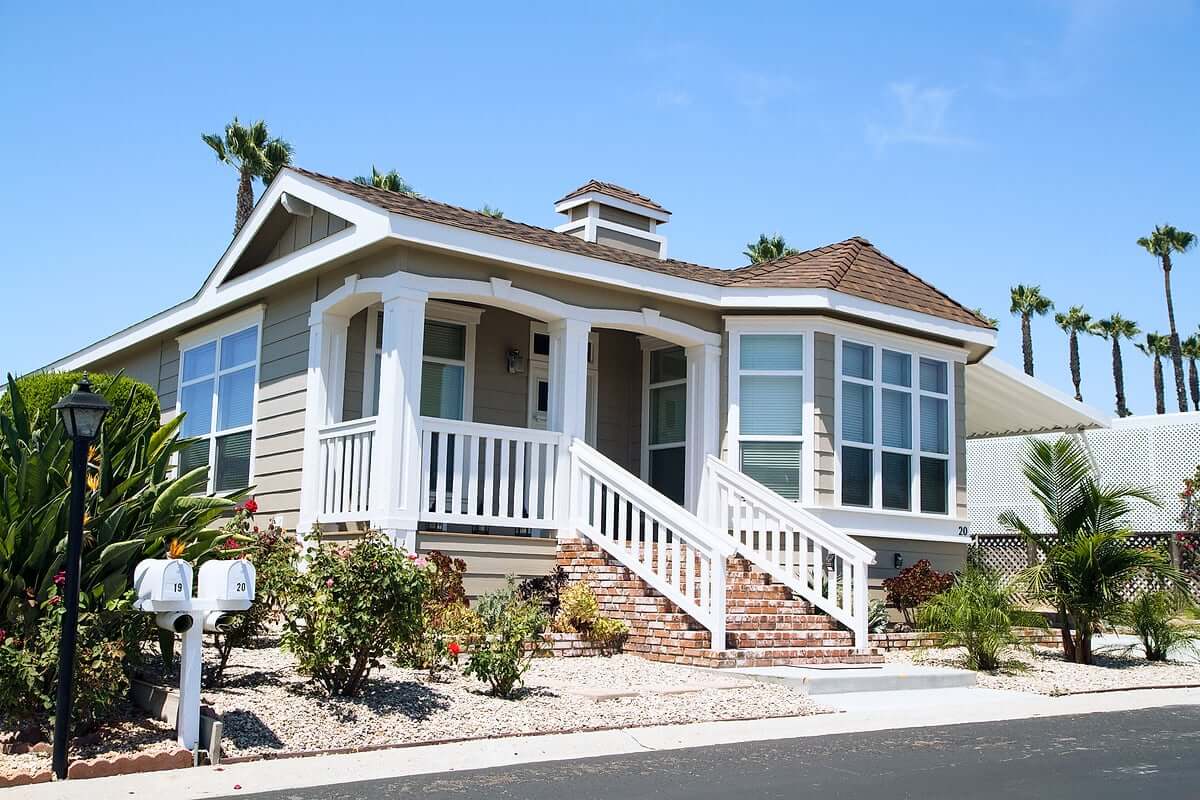 Upgraded manufactured home with landscaped yard and patio