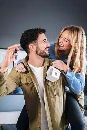 Happy family celebrating with keys to new home